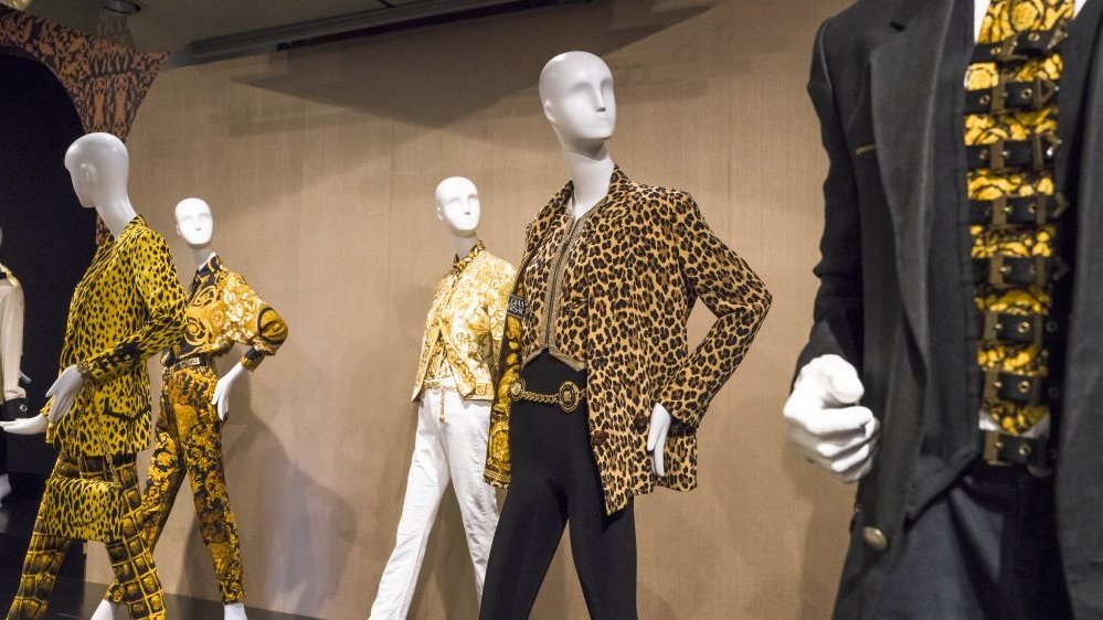 Mannequins in black and yellow outfits.