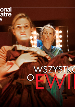 Two women in dressing room: one is standing in front of mirror, the other is standing behind her.