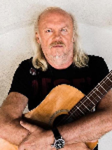 Photo of Andrzej Sikorowski - a man holding a guitar