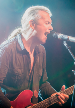 Photo of the musician - Andy Egert singing and playing the guitar