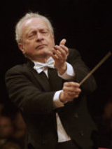 Photo of the conductor - a man with a conductor's baton in his hand on a black background