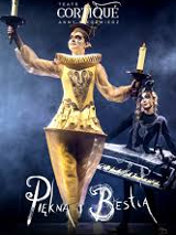 Photo of a woman dressed in a golden Lumiere (candelabra) costume against a dark background