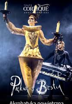 Photo of a woman dressed in a golden Lumiere (candelabra) costume against a dark background
