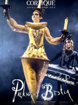 Photo of a woman dressed in a golden Lumiere (candelabra) costume against a dark background