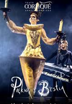Photo of a woman dressed in a golden Lumiere (candelabra) costume against a dark background