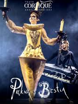 Photo of a woman dressed in a golden Lumiere (candelabra) costume against a dark background