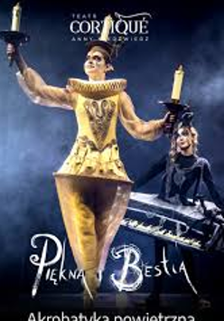 Photo of a woman dressed in a golden Lumiere (candelabra) costume against a dark background