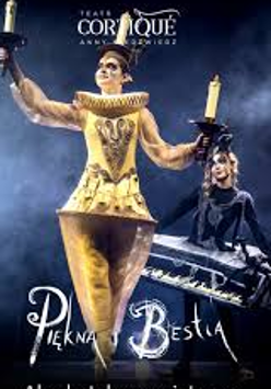 Photo of a woman dressed in a golden Lumiere (candelabra) costume against a dark background