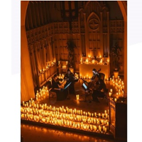 Photo of the stage surrounded by lit candles
