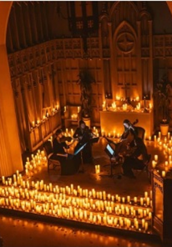 Photo of the stage surrounded by lit candles