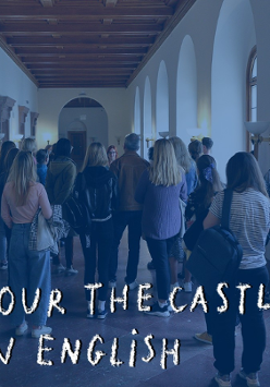 Photo of a group of people sightseeing in the Castle's corridor.