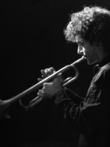 Black and white photo of the musician - a man playing the trumpet