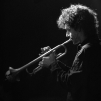 Black and white photo of the musician - a man playing the trumpet