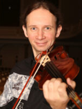 Photo of the artist - Marcin Herman playing the violin