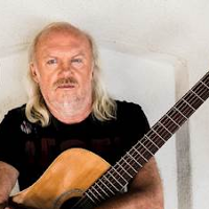 Photo of Andrzej Skorowski who holds a guitar.