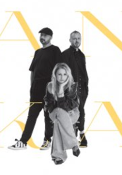 Photo of Ania Światczak sitting on chair. Two man standing behind her.