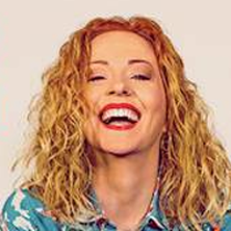 Photo of the artist's smiling face.