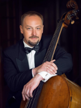 Photo of Szymon Guzowski, one of the concert performers, with his double bass.