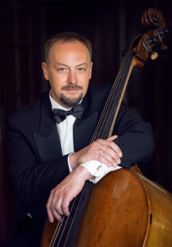 Photo of Szymon Guzowski, one of the concert performers, with his double bass.