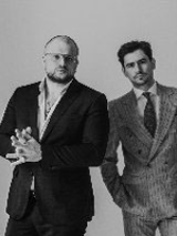 Black and white photo of two performers: Kacper Smoliński and Bartek Miler