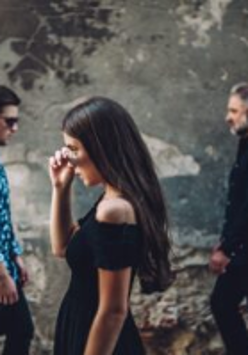 Photo of the band: one woman and two men.