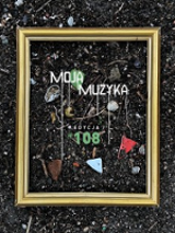 Concert poster: golden frame put on the ground, with some small objects inside it.