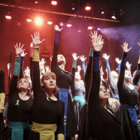 Photo of the girls with their hands up.