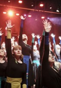 Photo of the girls with their hands up.