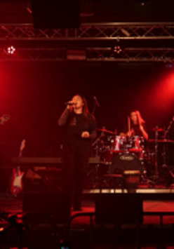 Photo of a band performing on stage.