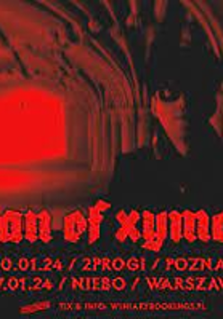Concert poster in black and red colours: photo of a man in a dark corridor and information about the event.