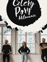 Photo of the band members - two men and one woman standing; big windows behind them.