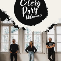 Photo of the band members - two men and one woman standing; big windows behind them.