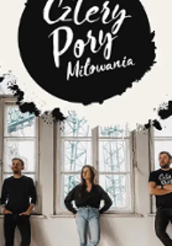 Photo of the band members - two men and one woman standing; big windows behind them.