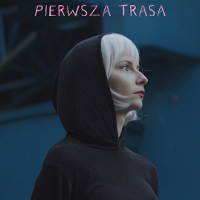 Photo of a young blond woman in a hood on her head. Dark-blue background.