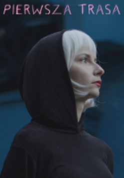 Photo of a young blond woman in a hood on her head. Dark-blue background.