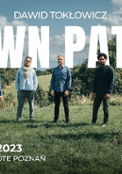 Photo of five men standing on the meadow.