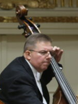 A photo of an artist Piotr Czerwiński playing double bass
