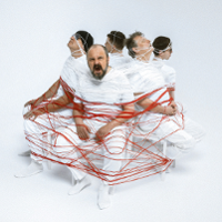 Photo of five men sitting on chairs and tied with a rope.
