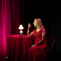 Photo of the woman sitting at the table.