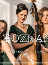 Photo of three women in green dresses, one of them is holding a double bass.