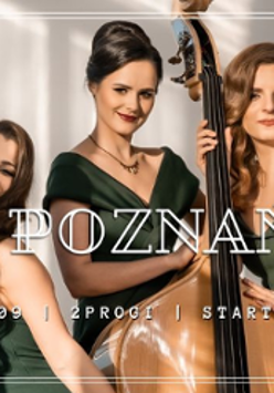 Photo of three women in green dresses, one of them is holding a double bass.