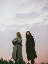 The photo shows the artists; as a background - the sky during twilight.