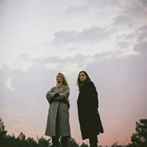 The photo shows the artists; as a background - the sky during twilight.