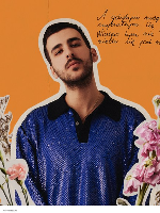 Picture of the artist among flowers on orange background.