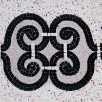 Black and grey photo of a mosaic made of small squares.