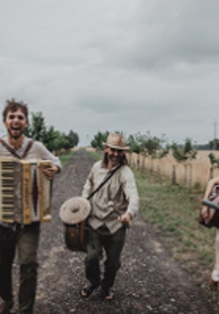 Photo of the band in folk costumes, holding musical instruments.