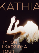 Concert poster: photo of a woman illuminated by white light, her name and the title of the concert tour.