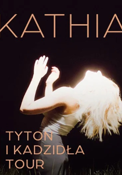 Concert poster: photo of a woman illuminated by white light, her name and the title of the concert tour.