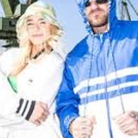 Photo of a young woman and a young man in jackets with hoods, blue sky as a background.