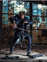 Photo of the artist - a young man playing the cello.